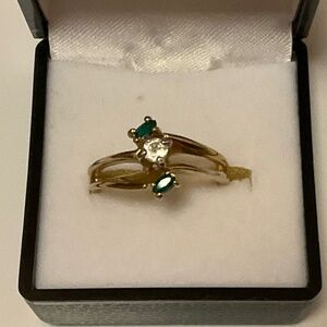 14kt yellow GE Esposito Emerald colored stones with clear center stone size 8